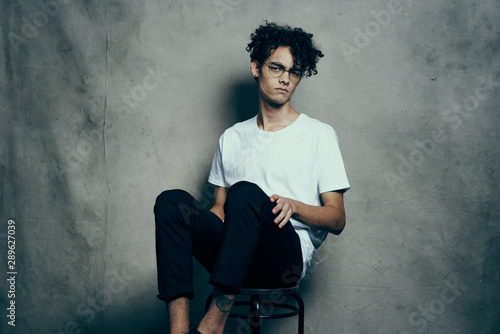 young man sitting on a chair © SHOTPRIME STUDIO