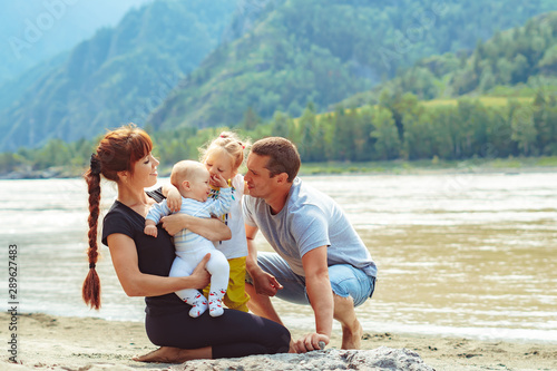 family with children on the river Bank