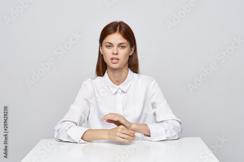 portrait of young woman sitting at her desk