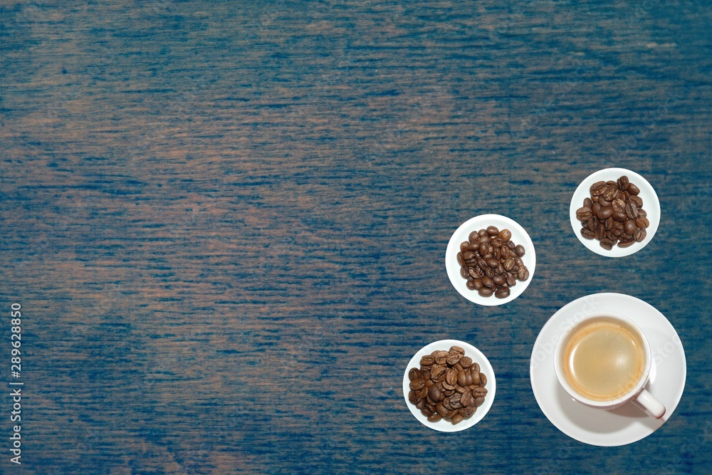 top view variety of roasted and green coffee beans on rustic background