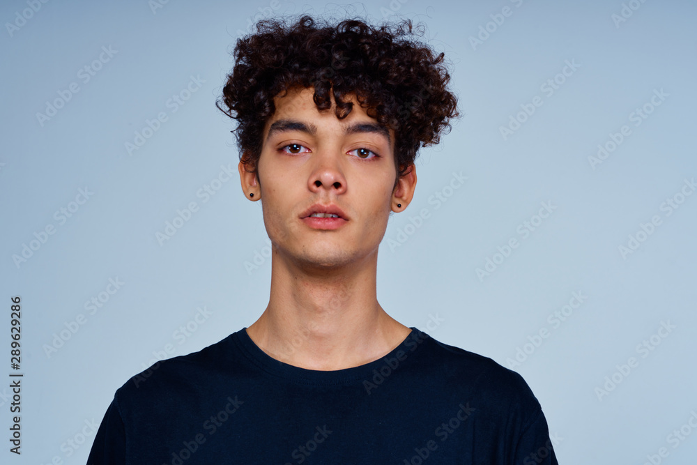 portrait of young man with long hair on black background portrait of young man with long hair on black background