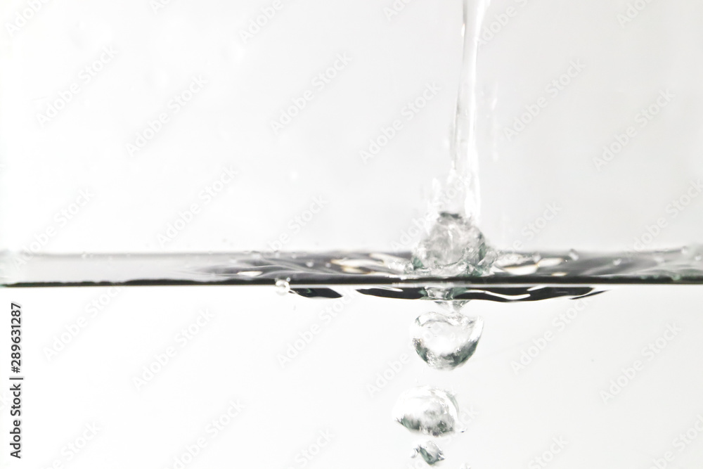 water splashing out of a glass isolated on white background water splashing out of a glass isolated on white background