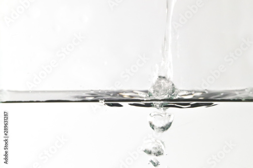 water splashing out of a glass isolated on white background