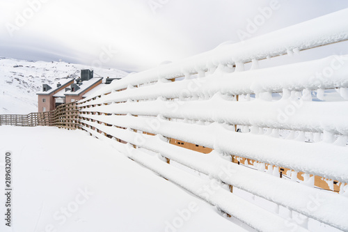 Winter mountains landscape with snowed fence in Sierra Nevada