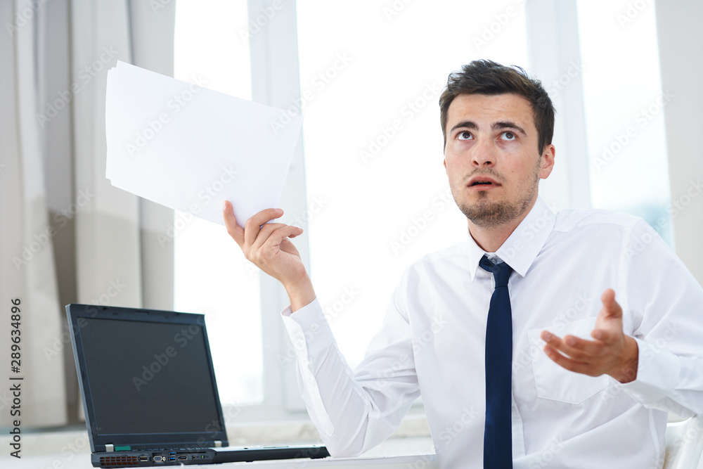 young businessman holding a blank business card young businessman holding a blank business card