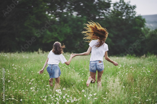 mother and daughter running in the field