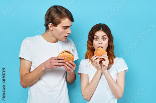 girl and boy eating pizza isolated on white