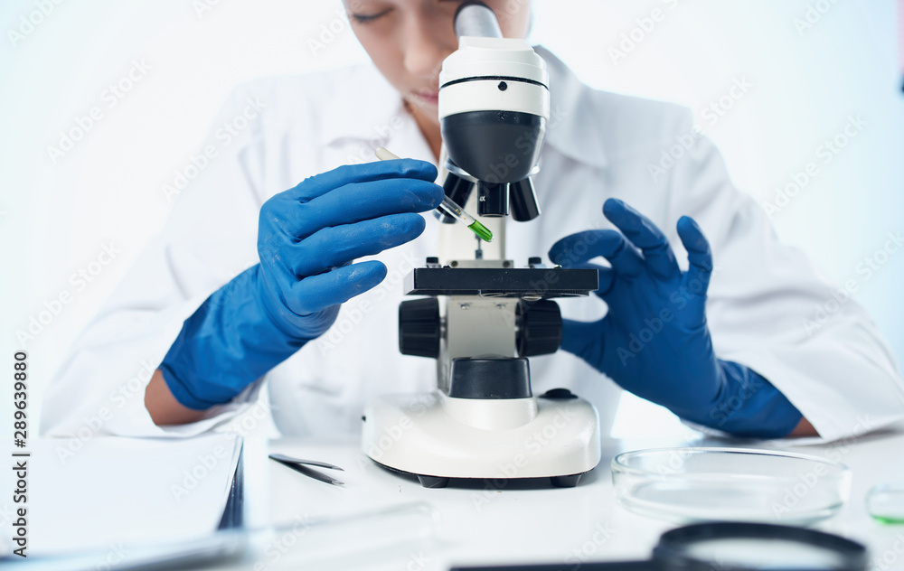 scientist looking through microscope scientist looking through microscope