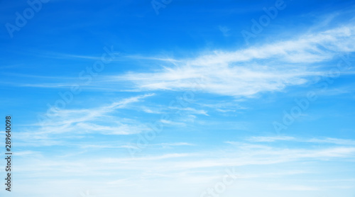 Sunny background, blue sky with white cirrus clouds 