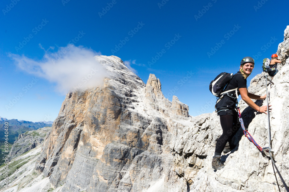 young attractive blonde female mountain climber in the Dolomites of Italy