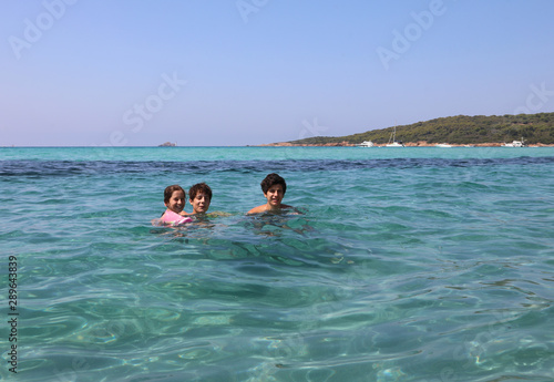 Young sister with two brothers in the sea © ChiccoDodiFC