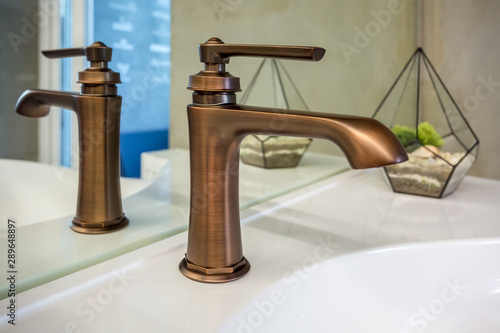 copper water tap sink with faucet in expensive loft bathroom