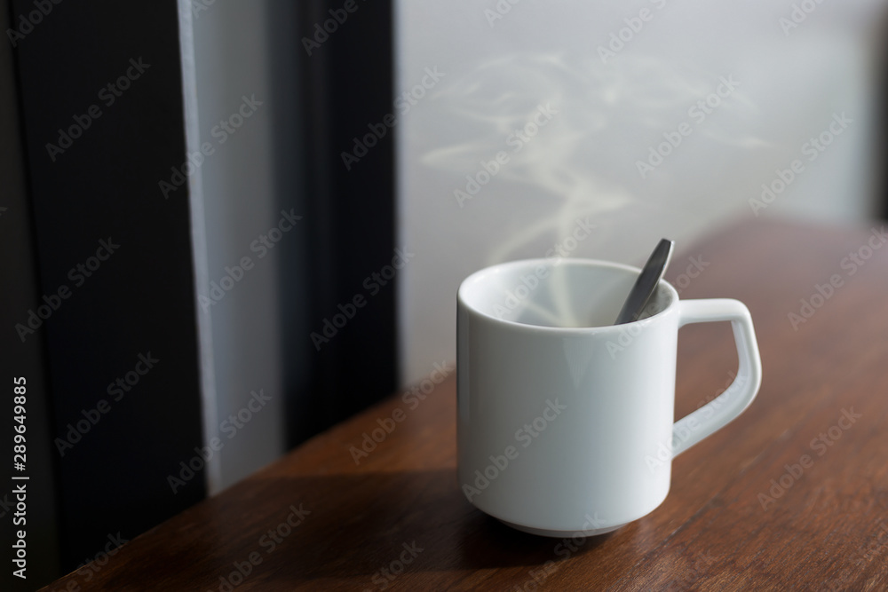 Coffee in a white cup on the table Coffee in a white cup on the table