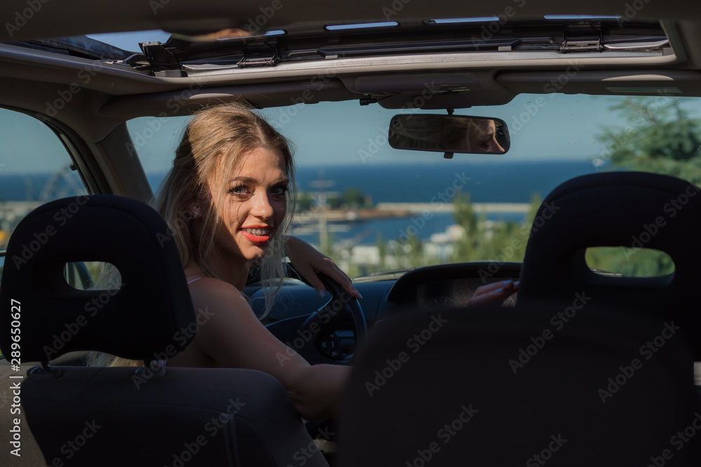 Young driver woman behind steering wheel