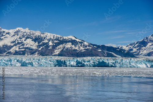 Hubbard Glacier in the sunshine with icebergs floating in the water.  © dabyg