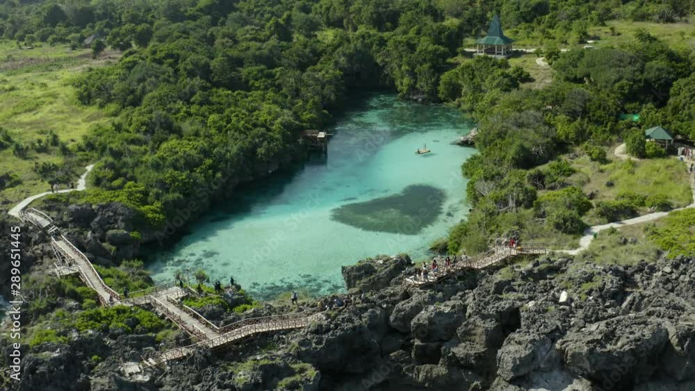 Backward drone shot above Weekuri Lake, Sumba, in front of the ocean Backward drone shot above Weekuri Lake, Sumba, in front of the ocean