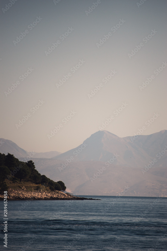 Vocation in Greece, Corfu. Water, cliff, mountains, and beautiful summer evening 