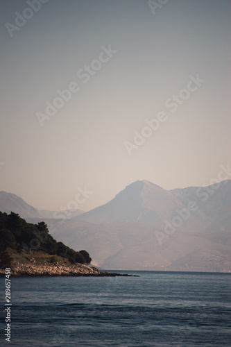 Vocation in Greece, Corfu. Water, cliff, mountains, and beautiful summer evening 