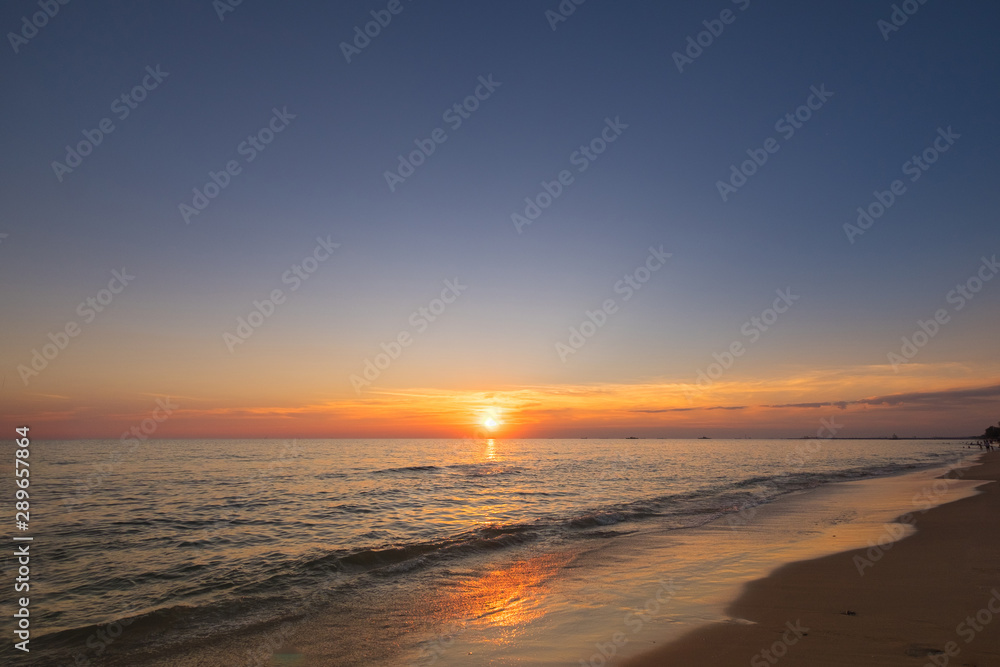 Vivid beautiful sunset and sunrise sky reflection on sea beach wave.