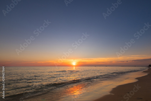 Vivid beautiful sunset and sunrise sky reflection on sea beach wave.