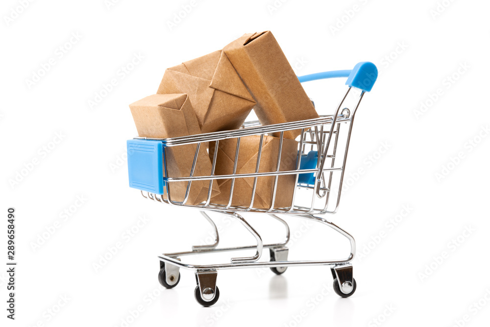 Online shopping concept. Shopping cart with small boxes inside on white background