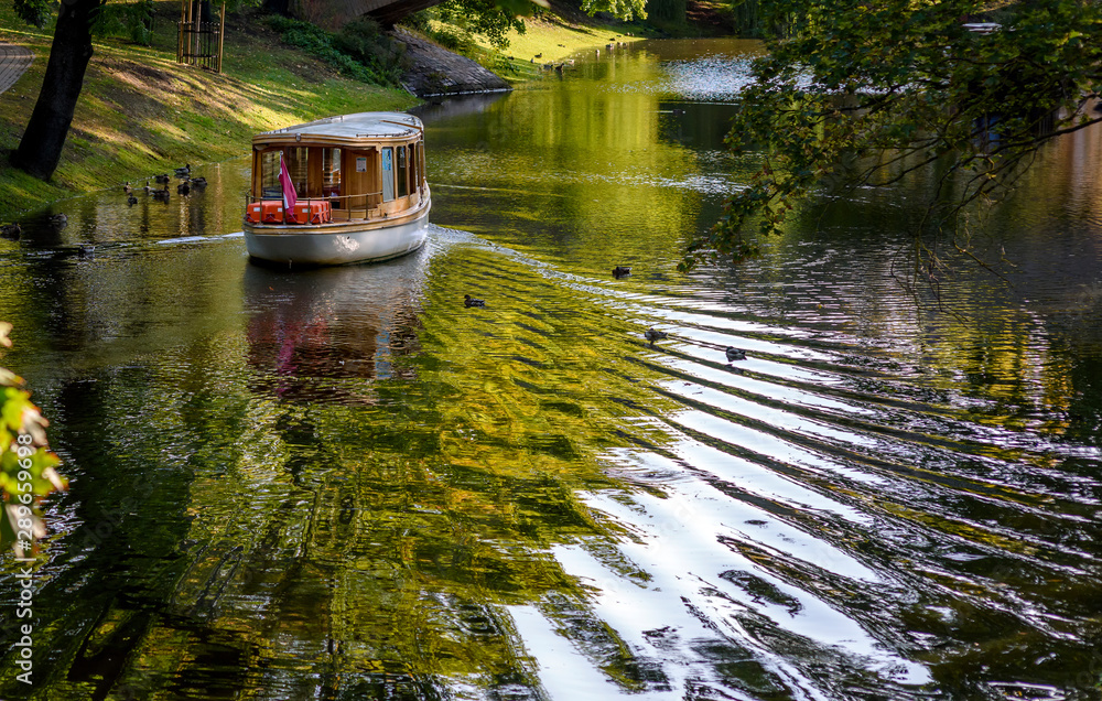 Boat passing through the city channel. Boat passing through the city channel.