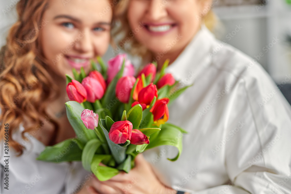 Mother and daughter with bright bouquet