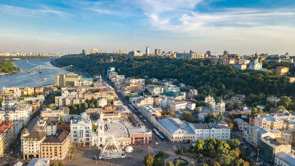 Aerial top view of Kyiv cityscape, Dnieper river and Podol historical district skyline from above, Kontraktova square with ferris wheel, city of Kiev, Ukraine
