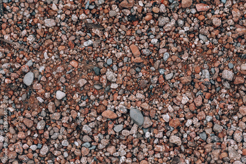 Background of small stones. Stones on the beach, pebbles. Beautiful texture with stones on the nature