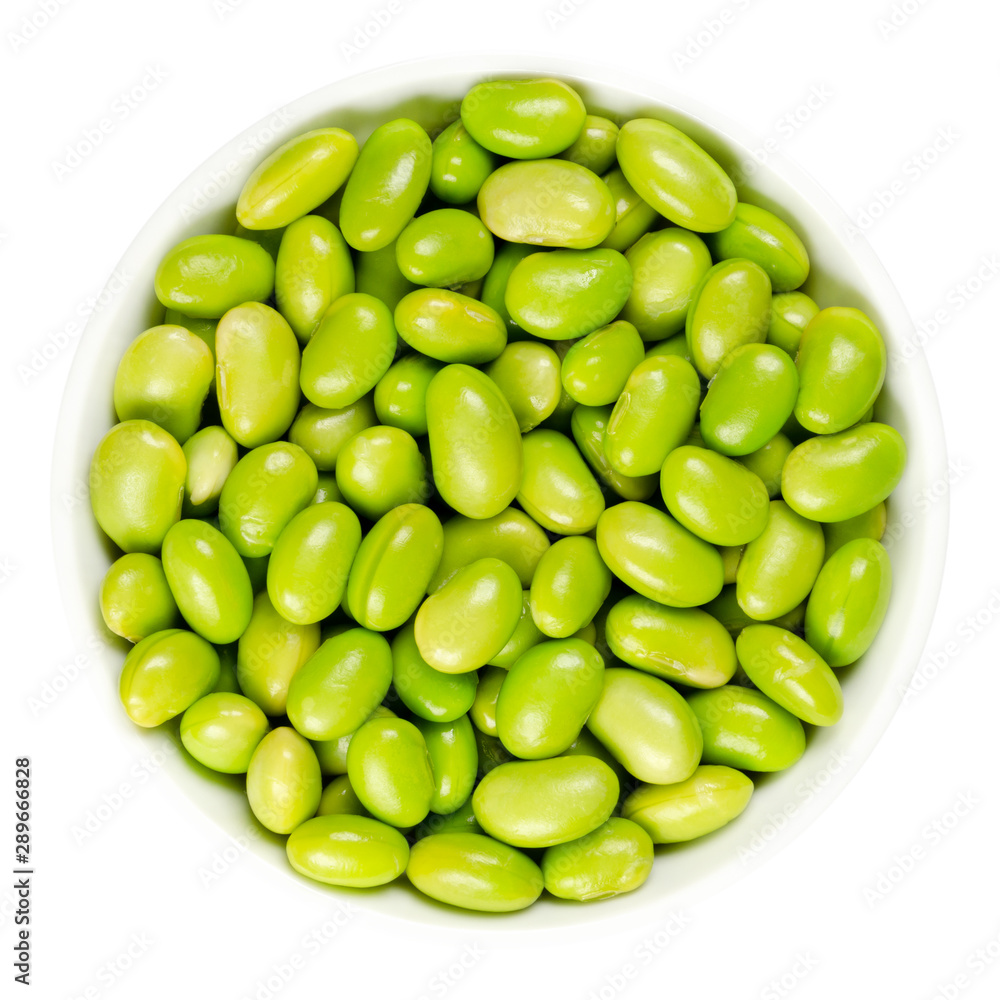 Edamame. Green soybeans in white bowl. Mukimame, unripe soya beans outside the pod. Glycine max, a legume, edible after cooking and a protein source. Closeup, on white background, macro food photo. Edamame. Green soybeans in white bowl. Mukimame, unripe soya beans outside the pod. Glycine max, a legume, edible after cooking and a protein source. Closeup, on white background, macro food photo.