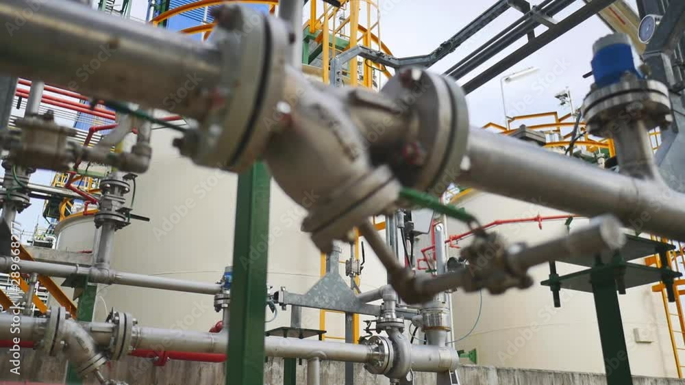 Chemical tank with product pipe line in the factory. Panning video Chemical tank with product pipe line in the factory. Panning video