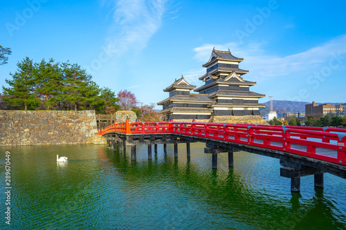 View of Matsumoto Castle with red bridge in Nagano, Japan