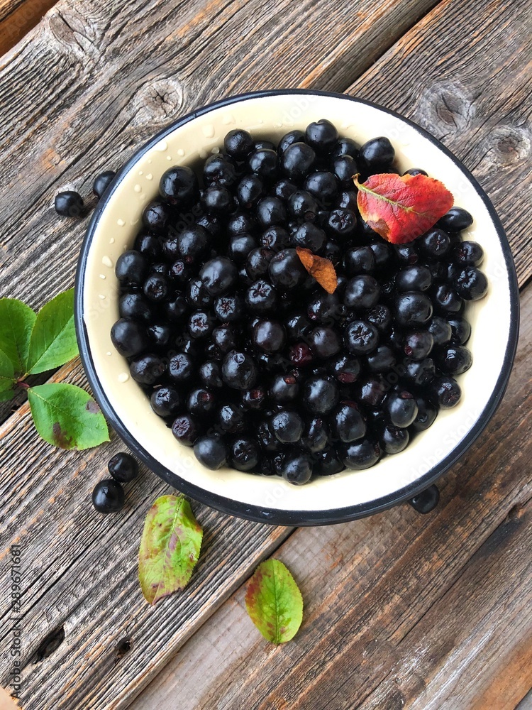 Fresh chokeberry on a wooden table view Fresh chokeberry on a wooden table view