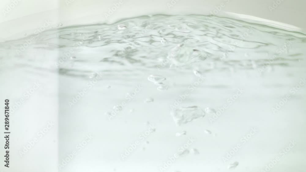 Amazing closeup macro shot of water boiling into a modern glass saucepan or casserole to prepare pasta or boiling food. Domestic utensil for cooking. Amazing closeup macro shot of water boiling into a modern glass saucepan or casserole to prepare pasta or boiling food. Domestic utensil for cooking.