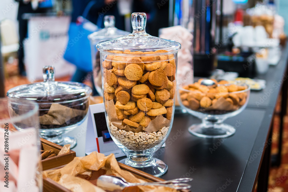 Shortbread cookies in glassware and other sweets on the buffet table during the coffee break