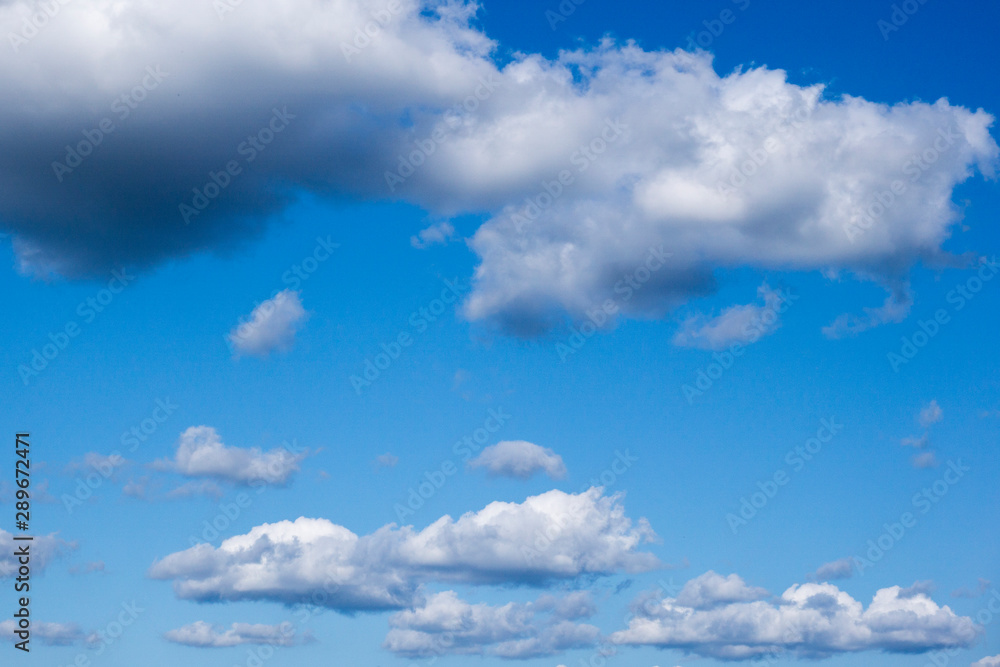 Light cloud in the bright blue sky on a sunny summer day