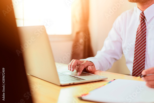 Asian businessman hands on the keyboard Working at home office with laptop,Data Processing business concept.