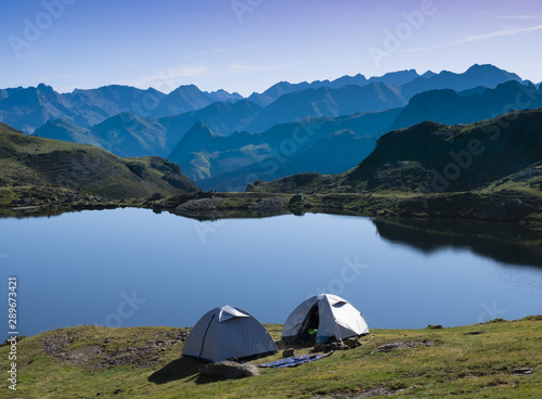 camping tent with the midi d'Ossau and the sun in the background in the Pyrenees National Park, France