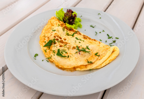 An Omelet with lettuce and a herbs