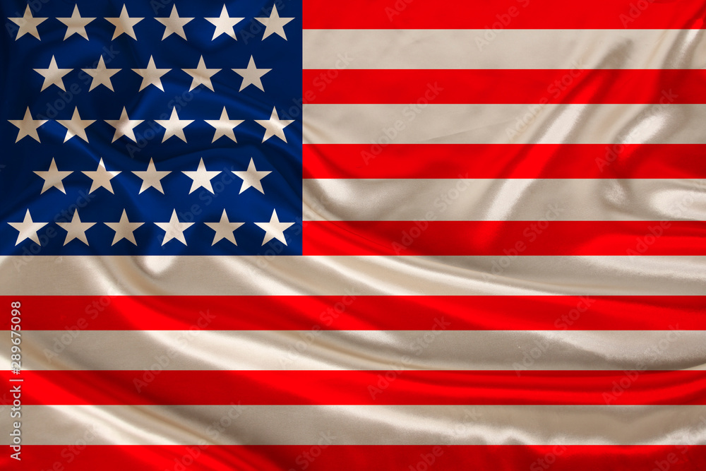 Naklejka premium national flag of the USA country on luxurious texture of satin, silk with waves, travel concept, immigration, politics