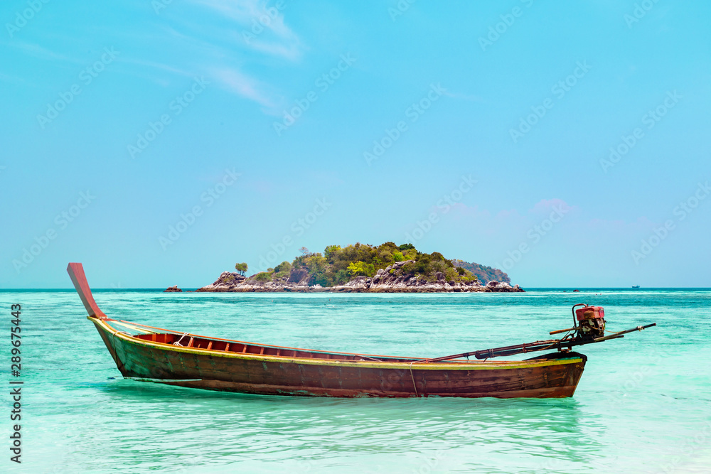 Traditional Thai wooden boat moored in a lagoon