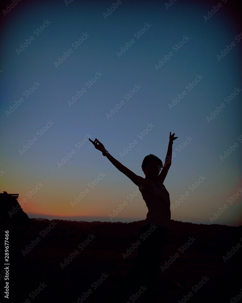 silhouette of man on top of mountain