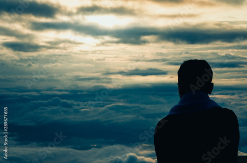 Silhouette of a man at the beautiful rise on the mountain and cloud. cinematic tone filter