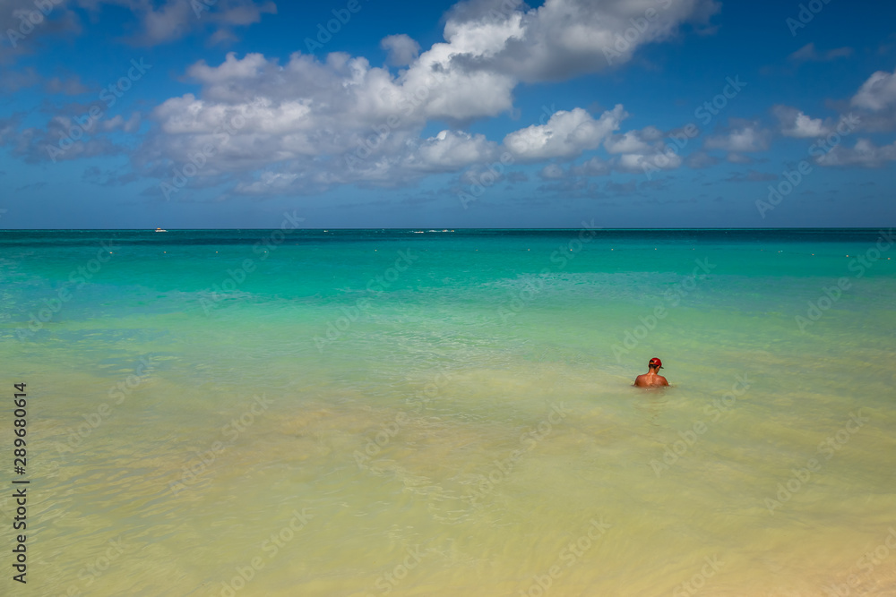Man swiming in Aruba Eagle Beach. Taken in 2017, this photo was taken in the beautiful Eagle Beach, Aruba, taking advantage of the great conditions at the time.