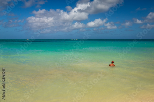 Man swiming in Aruba Eagle Beach. Taken in 2017, this photo was taken in the beautiful Eagle Beach, Aruba, taking advantage of the great conditions at the time.