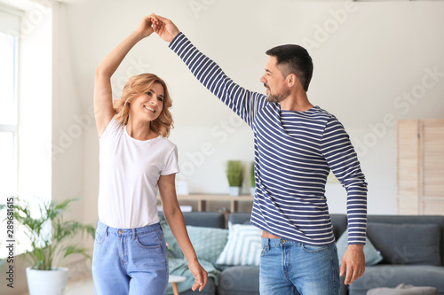 Happy dancing couple at home
