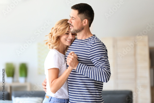 Happy dancing couple at home