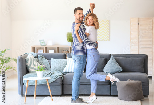 Happy dancing couple at home