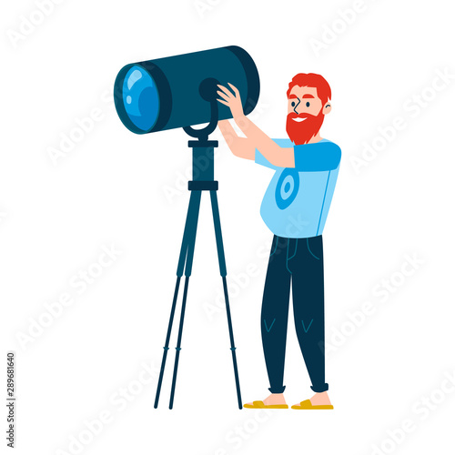 A red haired bearded caucasian man controls lighting equipment.