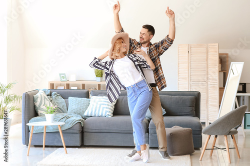 Happy dancing couple at home